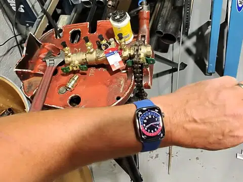 Hands working inside gas appliance control panel for index in Stanton