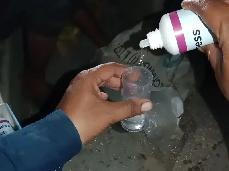 Purple water hardness test sample in small cup for golden state water stanton hardness effects plumbing in Stanton