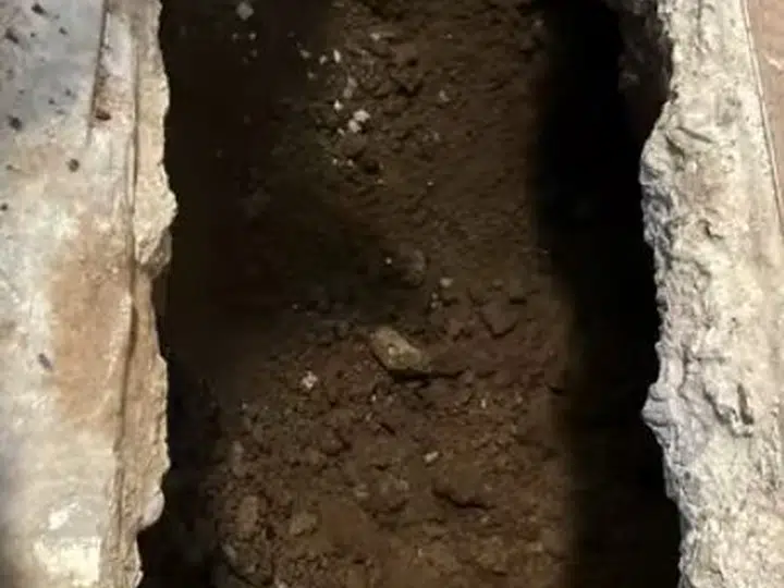 Narrow concrete trench opened for slab leak access for slab leak detection repair in Stanton