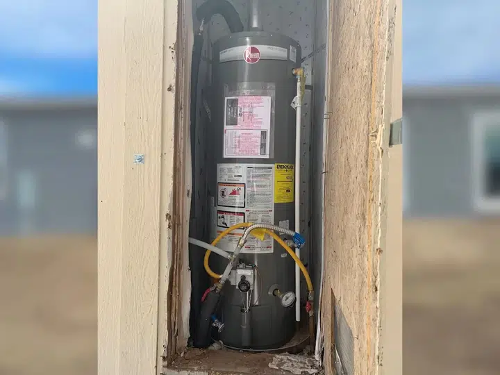 Water heater tank installed in exterior utility closet for water heater installation replacement in Stanton